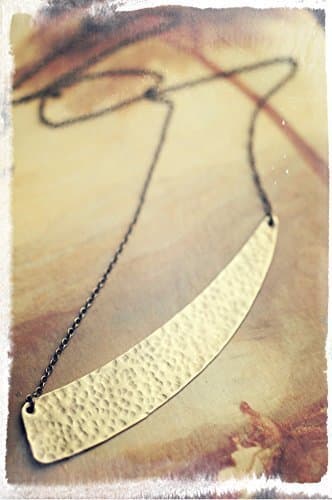Scythe geometric necklace, talisman for Lammas in hammered raw brass.