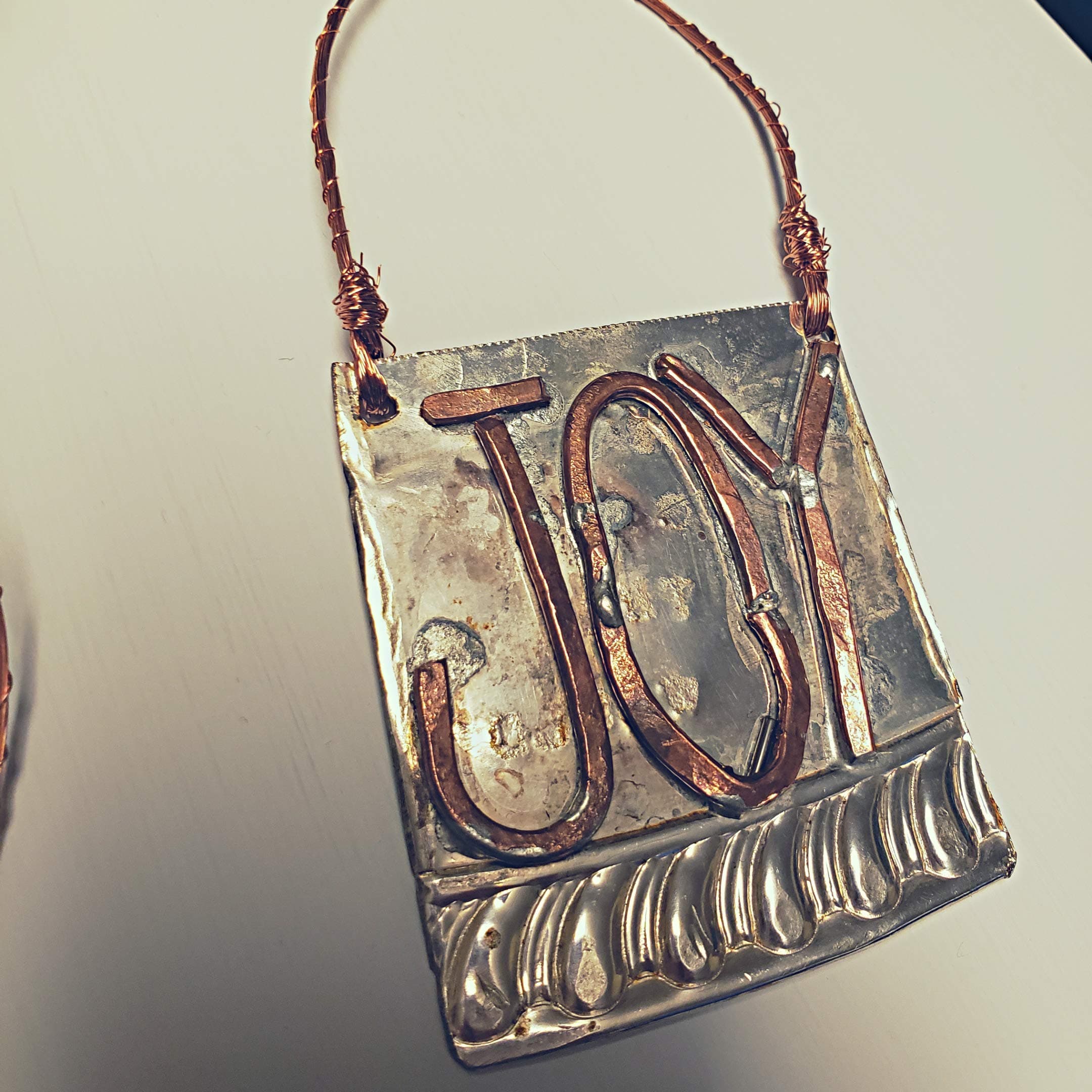 JOY Christmas ornament made from a reclaimed silver plated platter and wire