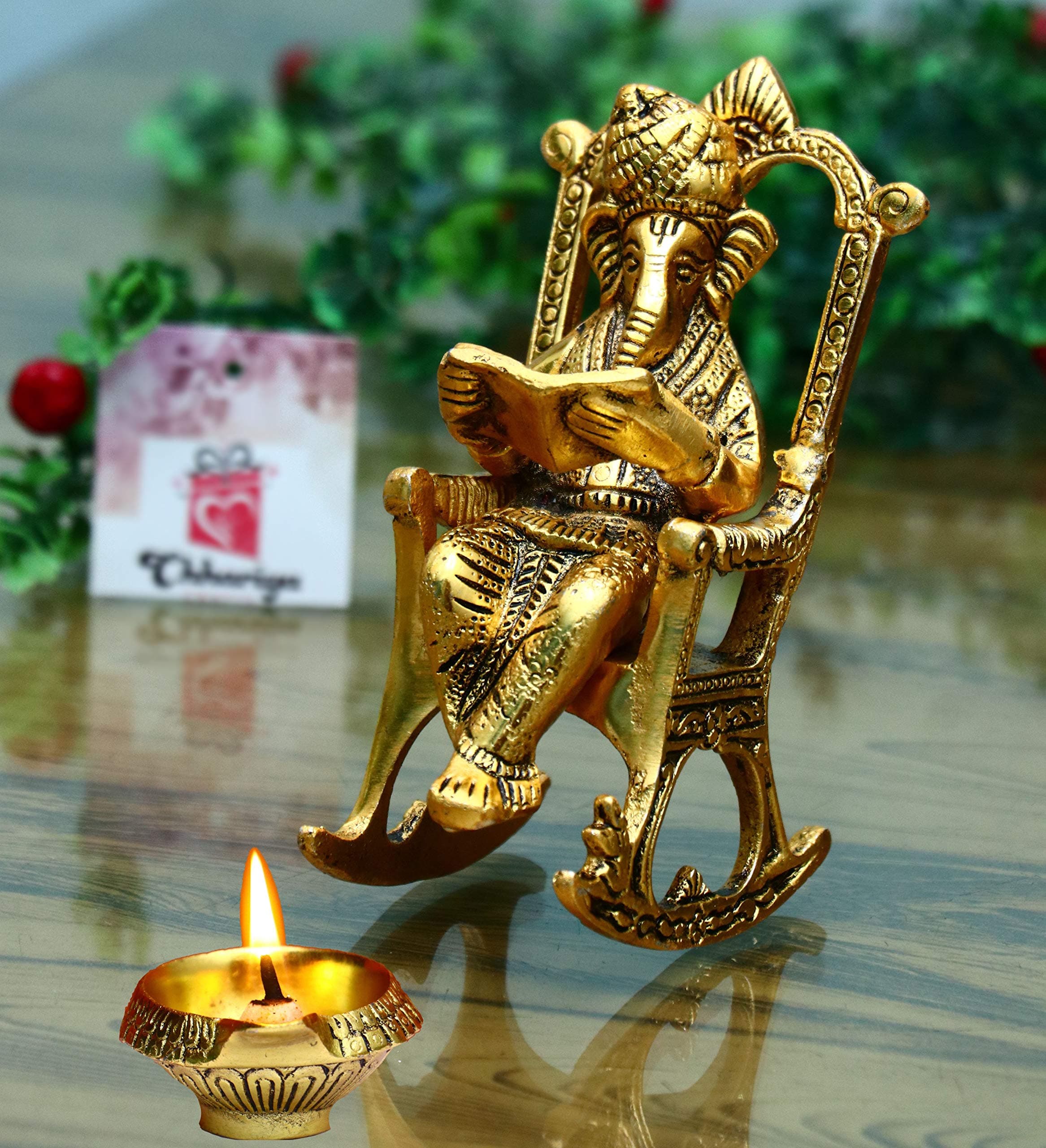 Metal Lord Ganesh Reading Ramayana Statue Ganpati Sitting on Chair with Kuber Diya Idol for Home Office and Gifts Decor Corporate Gifts Decorative Showpiece - 14 cm (Metal, Gold)