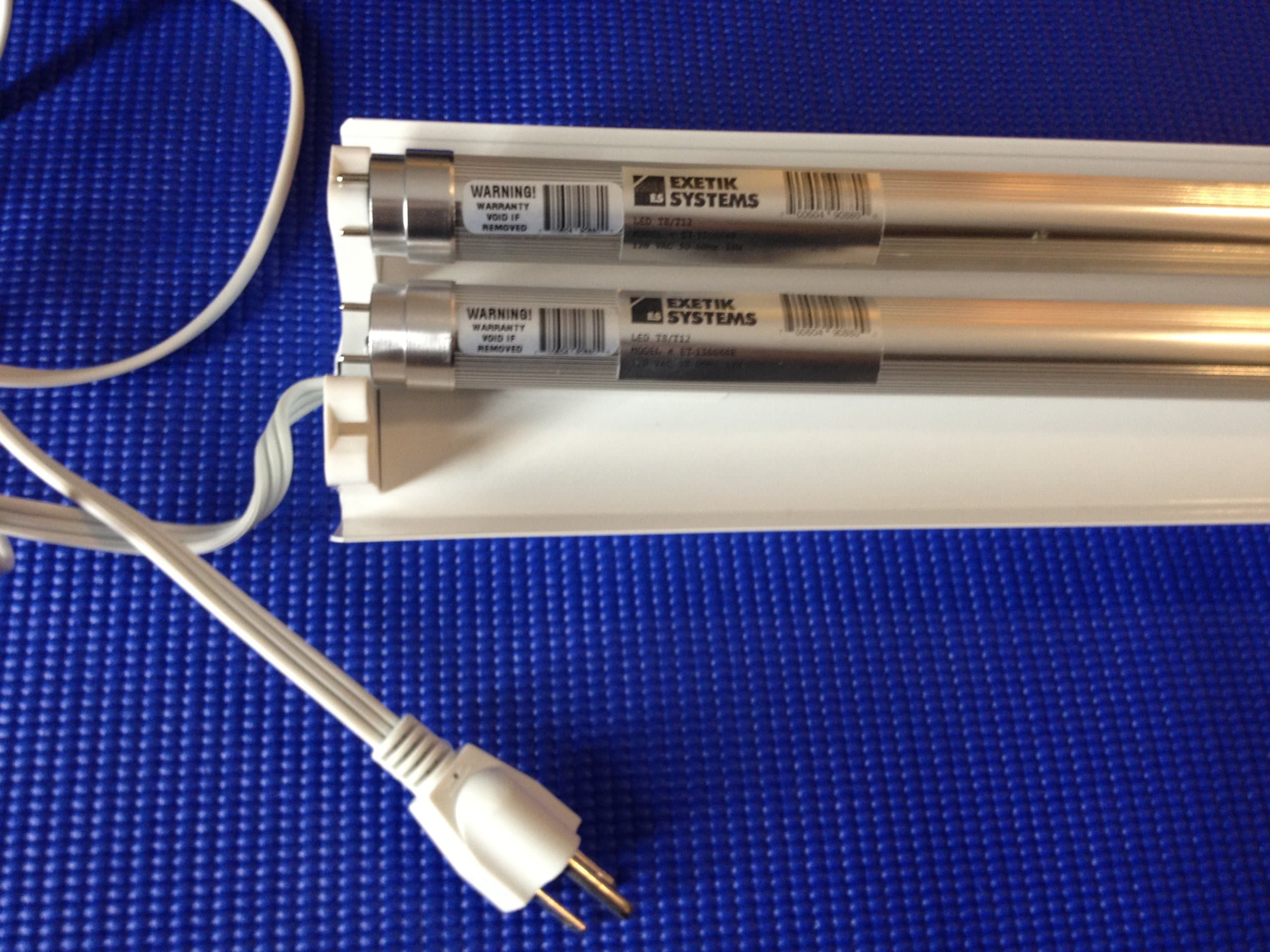 White plug-in LED Light Fixture with 2x 4ft Energy Efficient LED tubes. Perfect for garage, workbench, warehouse etc.